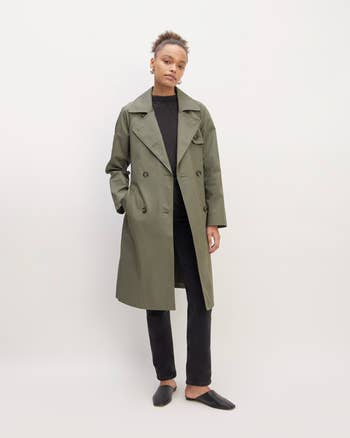 model wearing green trench coat