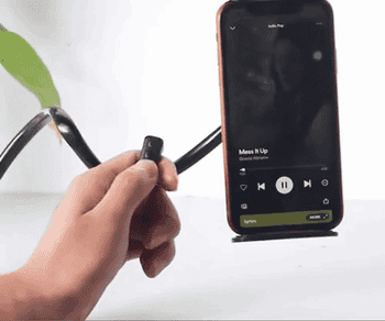 gif of someone using the black remote to skip songs on a playlist