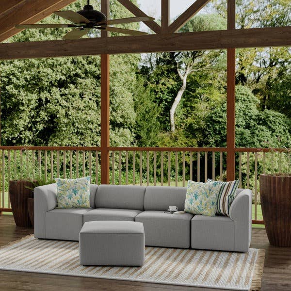 Outdoor sectional sofa with matching ottoman on a deck in color fresh gray