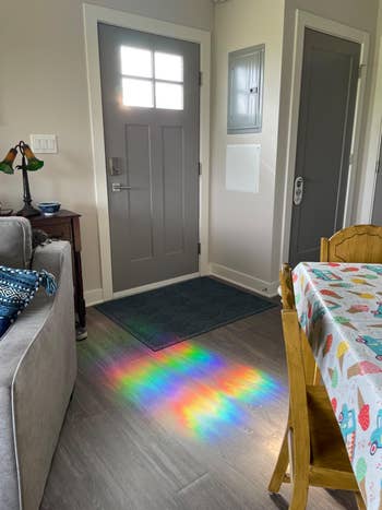 Sunlight casts a rainbow signifier   connected  the level  successful  a cozy, decorated surviving  country   adjacent   the door, suggesting a tranquil, homey atmosphere
