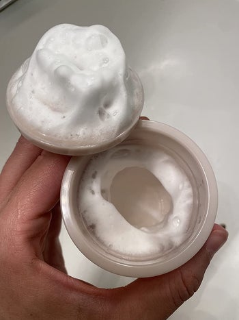 reviewer showing the foam made in the whip maker