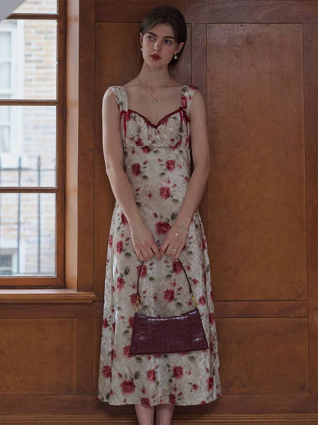 model wearing rose print dress