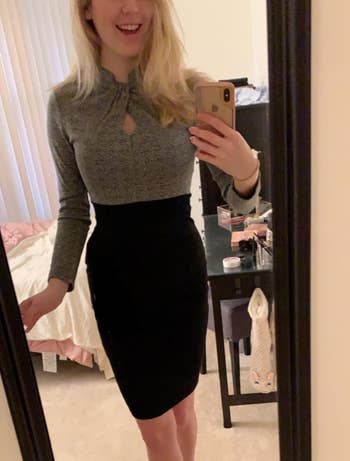 Image of reviewer wearing long sleeve gray and black dress