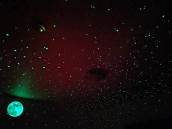 Ceiling with glowing stars and a moon decal creates a starry night effect, suitable for adding a calming ambiance to a room