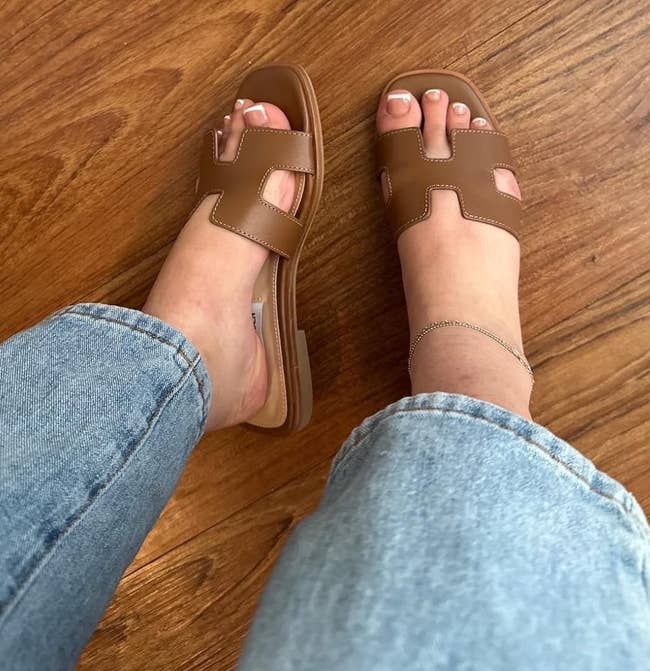 a reviewer wearing the brownish sandals