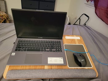 reviewer pic of same laptop desk with laptop and wireless mouse on top