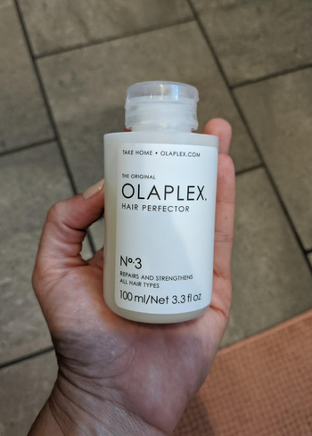 Bottle of Olaplex in a reviewer's hands 