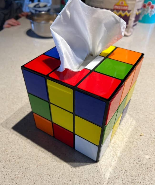 Tissue box cover designed to look like a Rubik's Cube on a counter