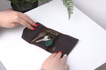 The inside of the brown key holder with keys inside