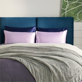 the lavender and navy satin pillowcases on pillows