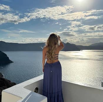reviewer showing strappy back of blue dress