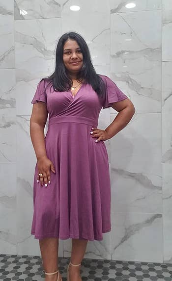 A reviewer wearing the dress in purple