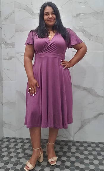 A reviewer wearing the dress in purple