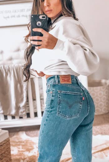 reviewer showing off back of jeans