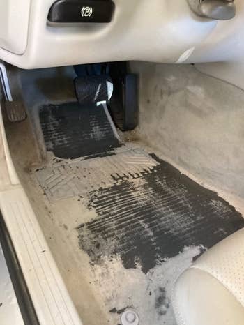 the floor of a reviewer's car looking dirty
