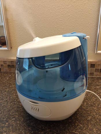 reviewer side photo of the humidifier emitting steam