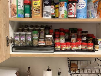 The same cabinet now with cabinet shelf with the spices now organized and easier to see