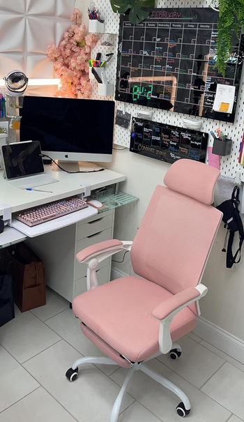 a reviewer's pink chair at their desk