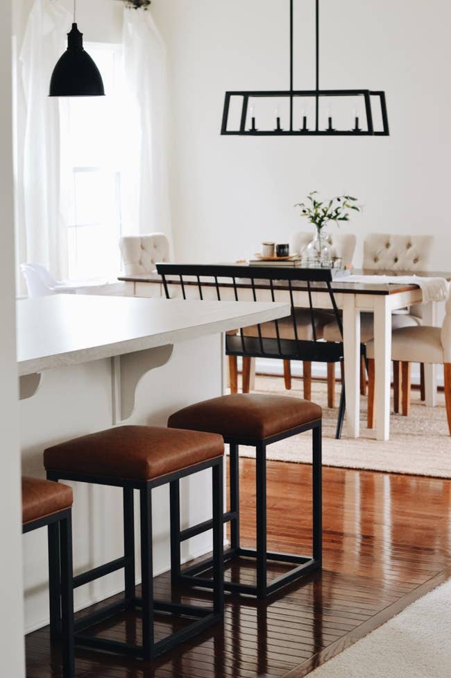 three brown topped square bar stools with black legs in a reviewer's home