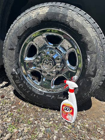 the bottle of iron out spray next to a car wheel that's been cleaned and left shiny