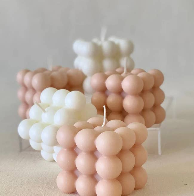 Five pink and white cube bubble candles
