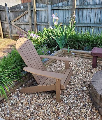 a brown adirondack chair by a fire pit