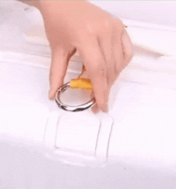 gif showing someone attaching a yellow strap to a white suitcase and hooking a black tote bag to it