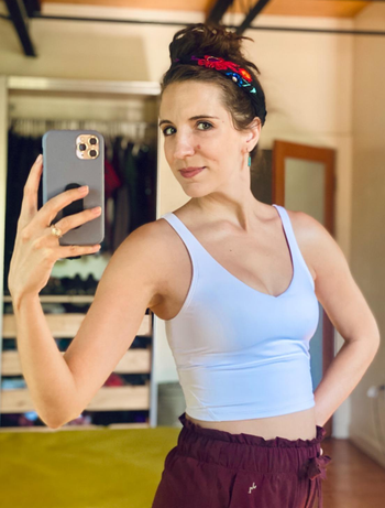 a reviewer selfie showing them wearing the cropped tank top in white 