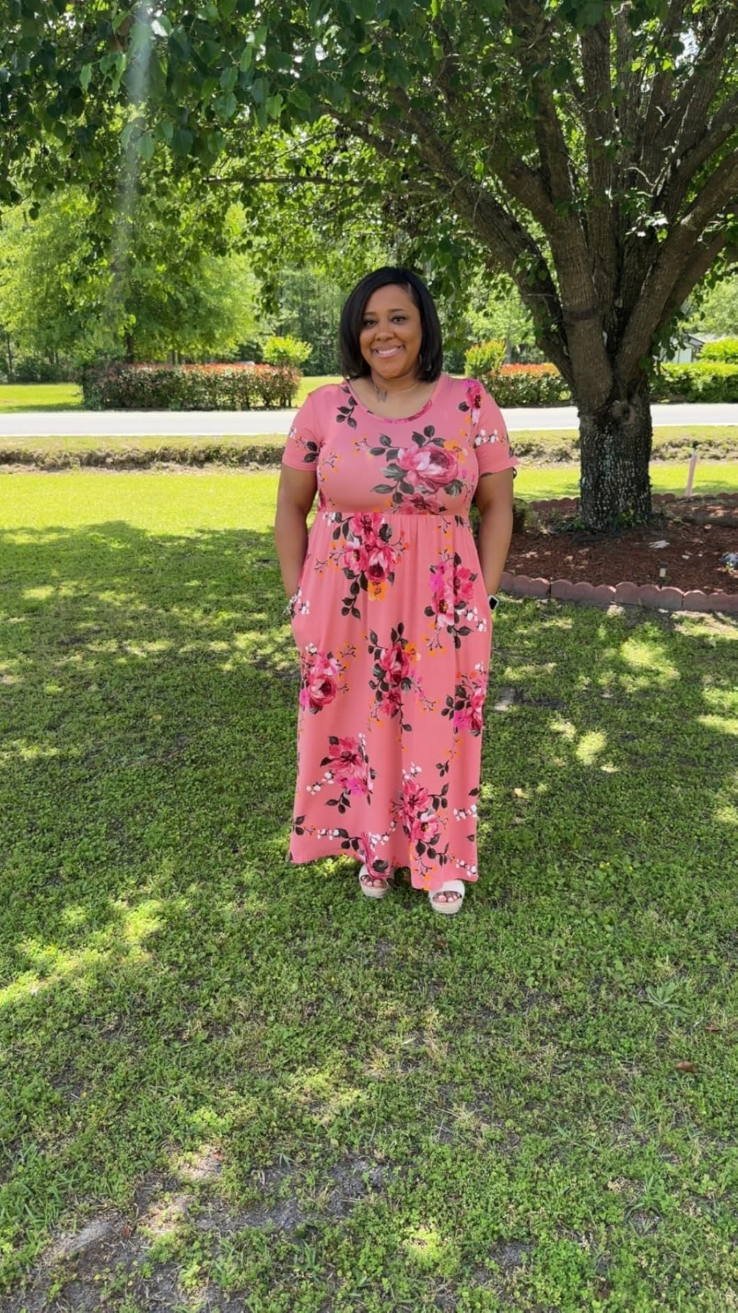 Person successful  a floral maxi formal  stands connected  writer  successful  a garden, smiling