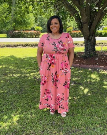 Person successful a floral maxi formal stands connected writer successful a garden, smiling