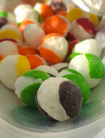 close up of reviewer's skittles showing where they are split apart from freeze drying 