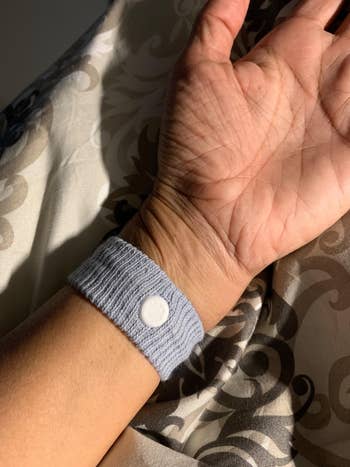 Seorang pengulas yang memakai gelang anti mual berwarna abu-abu