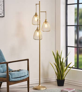 the gold-tone lamp lit up in a living room