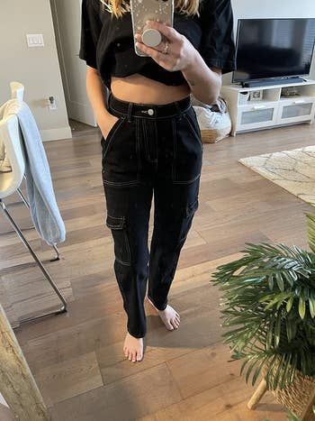 reviewer wearing the black pair with a cropped black T-shirt