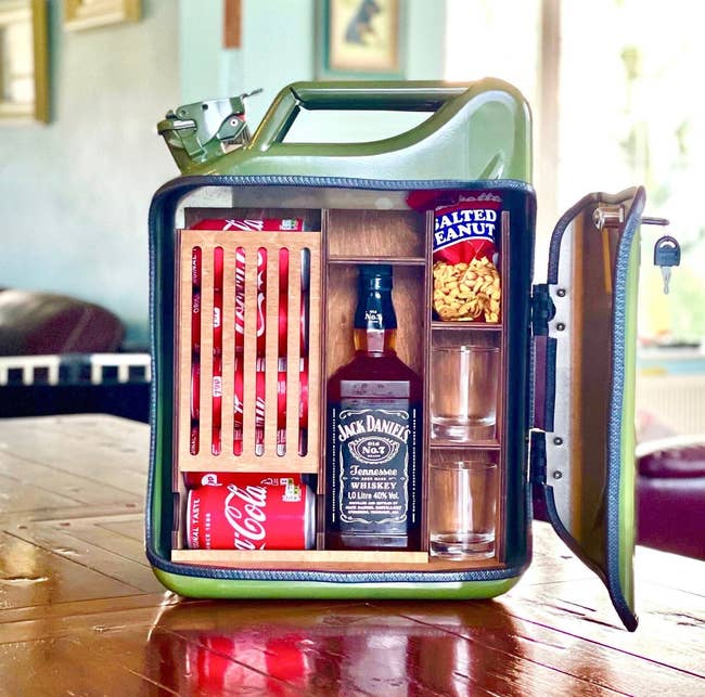 the mini bar with Jack Daniels, snacks, cokes, and two glasses in it