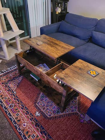 reviewer photo of storage coffee table with two lift-top trays