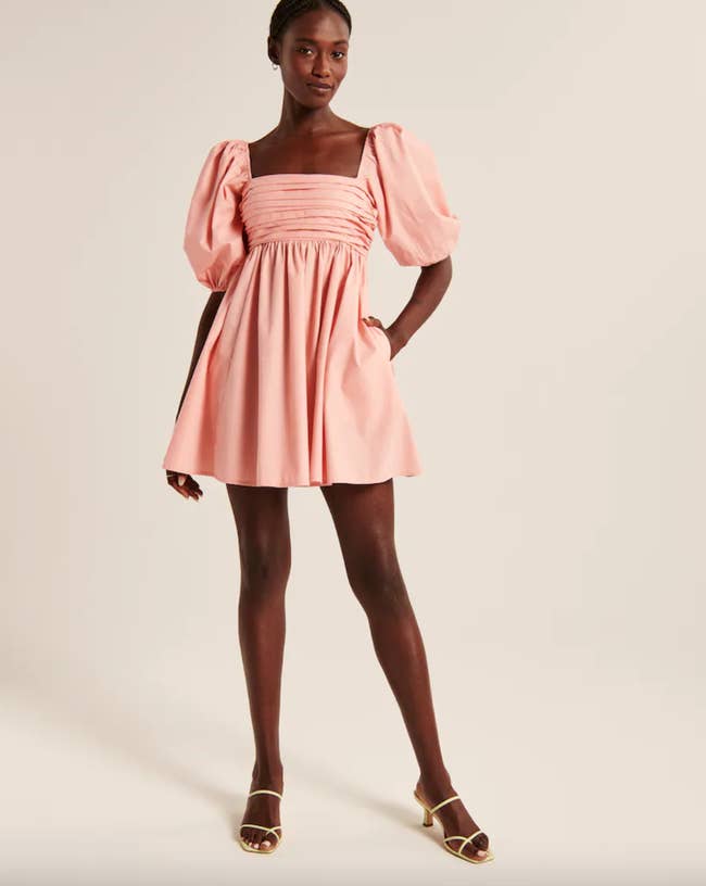 a model wearing the pink dress