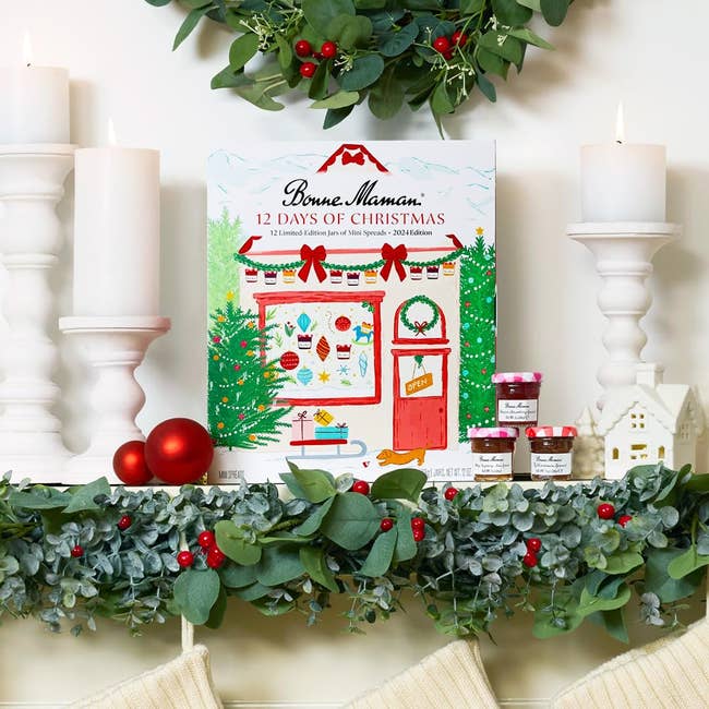 Advent calendar box, surrounded by festive decor, next to small jam jars. Text reads 