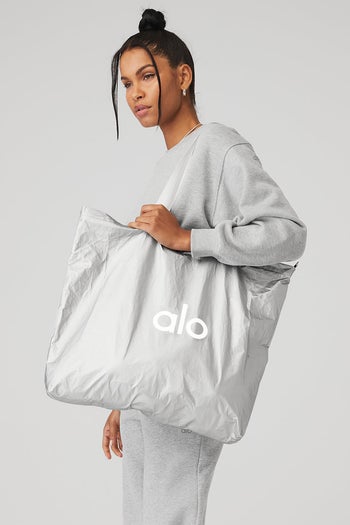 model carrying silver Alo Yoga tote