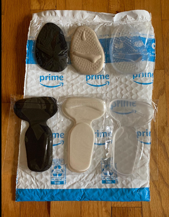 The shoe inserts in three colors laid out on the floor 