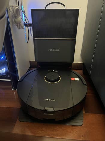 Roborock robot vacuum connected  a docking presumption    successful  a modern   location  setting, showcasing its sleek plan  and functionality for location  cleaning