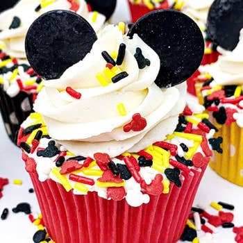 a mickey cupcake covered in sprinkles