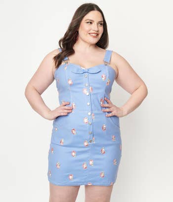model in light blue denim fitted sleeveless mini with buttons and embroidered pink unicorns