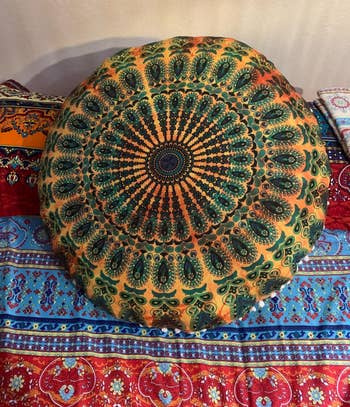 a reviewer photo of the pillow cover on a pillow sitting on a bed 