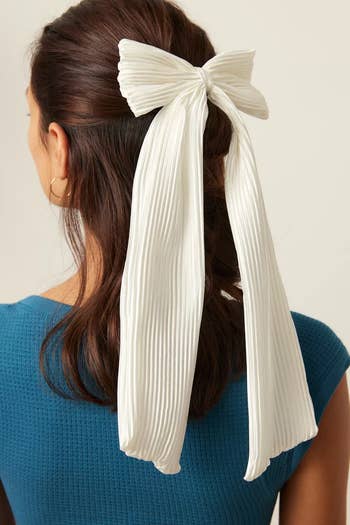 model wearing white pleated bow
