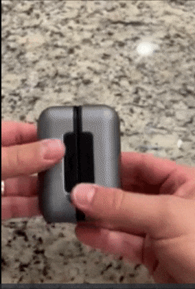 Reviewer dividing up two pieces of a small square hand warmer and pressing the control buttons
