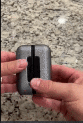 Reviewer dividing up two pieces of a small square hand warmer and pressing the control buttons 
