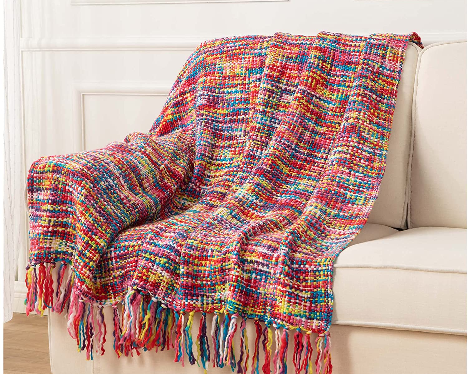 the rainbow blanket draped over a couch 