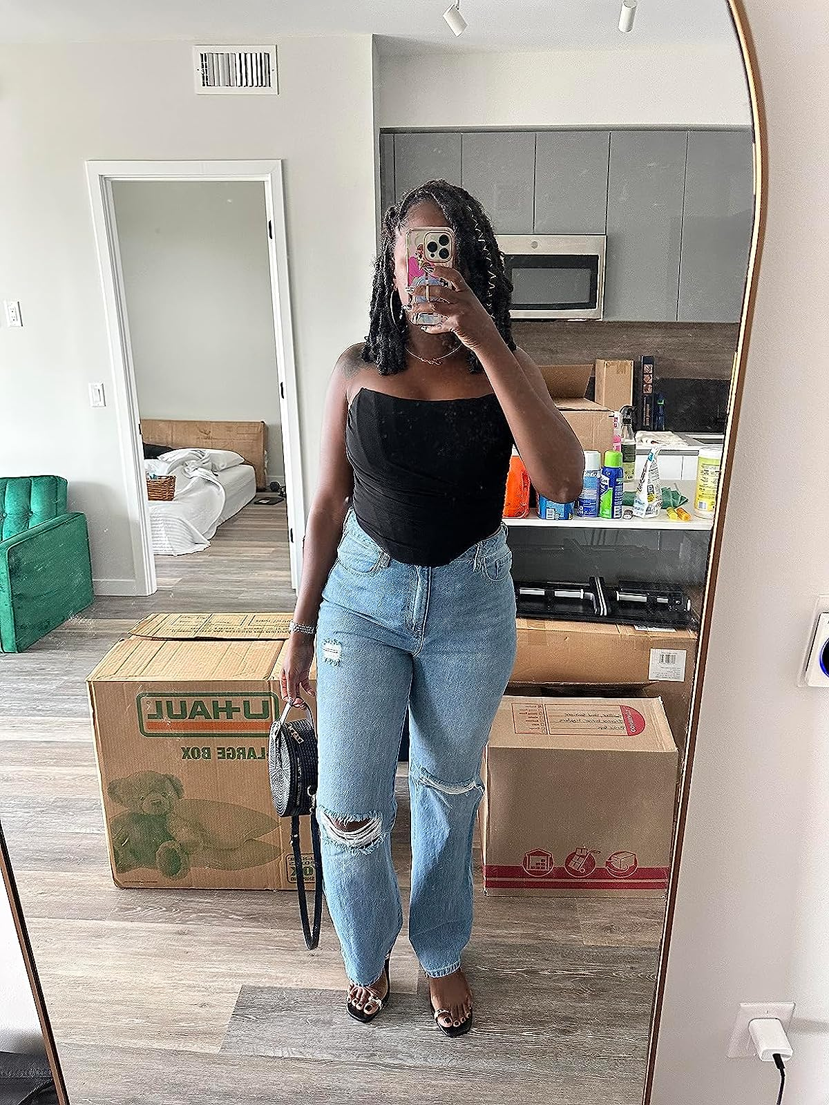 reviewer wearing the black corset and jeans