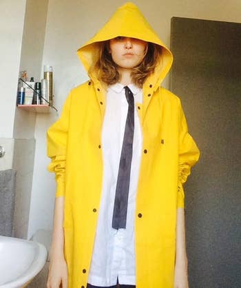 reviewer wearing the yellow trench raincoat